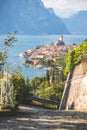 Idyllic coastline scenery in Italy: Blue water and a cute village at lago di garda, Malcesine