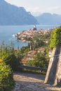 Idyllic coastline scenery in Italy: Blue water and a cute village at lago di garda, Malcesine Royalty Free Stock Photo