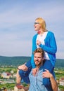 Idyllic date concept. Man carries girlfriend on shoulders, sky background. Couple in love enjoy perfect date sunny day