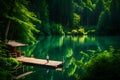 An idyllic forest by the edge of a tranquil lake, where the emerald waters reflect the lush greenery and the clear blue sky above Royalty Free Stock Photo