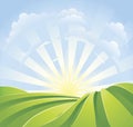 Idyllic green fields with sunshine rays Royalty Free Stock Photo