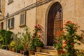 Beautiful front door with flower pots of a mediterranean rustic house