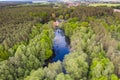 Idyllic house near a forest lake nestled in a deciduous forest in spring