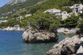 Idyllic islet on Punta Rata beach in Brela, Makarska riviera of Dalmatia, Croatia symbol tree stone of Brela Royalty Free Stock Photo