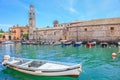 Idyllic lake Garda coastline in Lazise with boat, Northern Italy