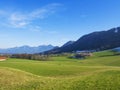 Idyllic landscape in the Alps with fresh green meadows and blooming flowers Royalty Free Stock Photo