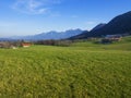 Idyllic landscape in the Alps with fresh green meadows and blooming flowers Royalty Free Stock Photo