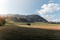 Idyllic landscape in the Alps with meadows in the autumn at sunset. Royalty Free Stock Photo