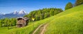 Idyllic landscape in the Alps with traditional mountain lodge in spring Royalty Free Stock Photo