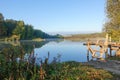 Idyllic landscape of the lake. A bridge made of planks for a fisherman or a mooring for a boat Royalty Free Stock Photo