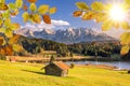 idyllic landscape with mountain range, lake and cottage at autumn. Royalty Free Stock Photo