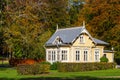 Idyllic little yellow cottage with autumn colors on the trees Royalty Free Stock Photo