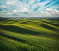 idyllic meadow vista panorama with green hills covered in grass and blue sky with cumulus clouds, desktop background