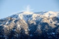 Idyllic Mountain and Forest Landscape on winter. Snowy slopes, rocks, cliffs and peaks. Panoramic view of mountain at sunset. Royalty Free Stock Photo