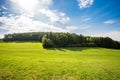 Scenic panoramic view of idyllic rolling hills landscape with blooming meadow, beautiful sunny day with blue sky and clouds Royalty Free Stock Photo