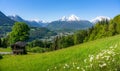 Idyllic mountain scenery with traditional mountain chalet in the Alps in summer Royalty Free Stock Photo