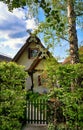 Idyllic old house with thatched roof and front garden with garden gate Royalty Free Stock Photo