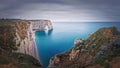 Idyllic panorama of Porte d\'Aval natural arch at Etretat famous cliffs washed by Atlantic ocean,