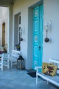 Idyllic porch with comfy chairs and benches, situated on an inviting walkway