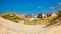 Idyllic and quaint beach houses seen from beach dunes. Beach houses with colorful stripes from Costa Nova, Aveiro, Portugal