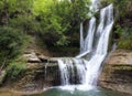 Idyllic rain forest waterfall, stream flowing in the lush green forest. Royalty Free Stock Photo