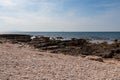 Idyllic rocky beach in tourist coastal town Medulin, Istria peninsula, Croatia, Europe. Panoramic view of rugged coastline Royalty Free Stock Photo