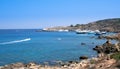 Idyllic rocky coastline with turquoise sea water and moored yachts at summer.