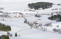 Lovely rural countryside on snowy winter day. Aerial view of barnyards and farm. Weitnau, Allgau, Bavaria, Germany.