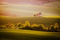 Idyllic rural landscape with an old mill. Sunlight on Wavy fields in Kunkovice village.