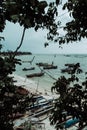 Idyllic scene featuring a peaceful beach with a row of boats on a serene shoreline