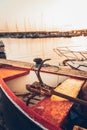 Idyllic scene of an old sailboat docked on a pier, with sun-soaked water in the background Royalty Free Stock Photo