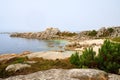 Idyllic scene of a peaceful ocean with rocky shorelines under a clear, blue sky