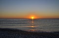 Idyllic scene of sunrise on horizon, red sky and sea