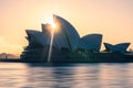 Idyllic scene of Sydney Opera House with the sun setting behind it