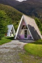 Idyllic scene of triangular-shaped homes in a lush park in Makarora, New Zealand