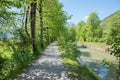 Idyllic shady walkway along rottach river, under green trees, upper bavaria Royalty Free Stock Photo