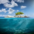 Idyllic small island with lone tree in the ocean Royalty Free Stock Photo