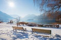 idyllic snowy scenery at spa garden Schliersee with two benches and lake view, bavaria