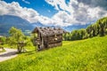 Idyllic spring landscape in the Alps with traditional mountain chalet Royalty Free Stock Photo
