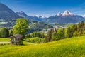 Idyllic spring landscape in the Alps with traditional mountain chalet Royalty Free Stock Photo