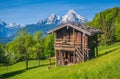 Idyllic springtime landscape in the Alps with traditional mountain lodge Royalty Free Stock Photo