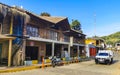 Idyllic street houses people cars hotels stores Mazunte Mexico Royalty Free Stock Photo