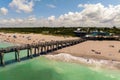 Idyllic summer day over sandy beach at Venice fishing pier in Florida. Summer seascape with surf waves crashing on sea