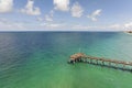 Idyllic summer day over Venice fishing pier in Florida. Summer seascape with surf waves crashing on sea shore