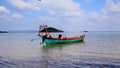 Idyllic summer scene of the ambient motion of a traditional khmer fishing boat lulled in the gentle waves