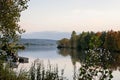 Idyllic sunset over lake in autumn. Sunset boat on lake. Colorful trees reflection in the water. Lake Slnava, Piestany, Slovakia. Royalty Free Stock Photo