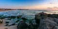 waves crashing rocks on sandy beach Royalty Free Stock Photo