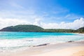 Idyllic tropical beach in Caribbean with white sand, turquoise ocean water and blue sky