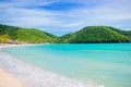 Idyllic tropical Carlisle bay beach with white sand, turquoise ocean water and blue sky at Antigua island