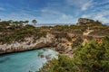 Idyllic view of beautiful ocean by cliff in island against blue sky Royalty Free Stock Photo